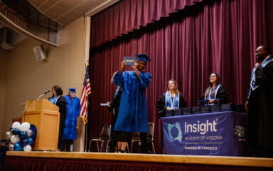 JaQuan celebra en el escenario tras recibir su diploma de secundaria en la ceremonia de graduación de la Academia Insight de Arizona.